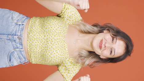 Vertical-video-of-Happy-young-woman-rejoices.